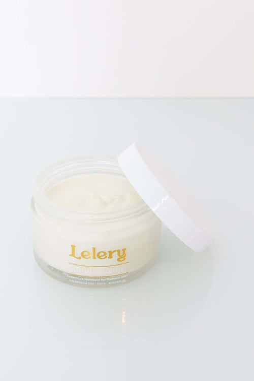 Whipped Body Butter for Glowing Skin in a clear jar with a white lid, promoting deeply hydrating and non-greasy skin.