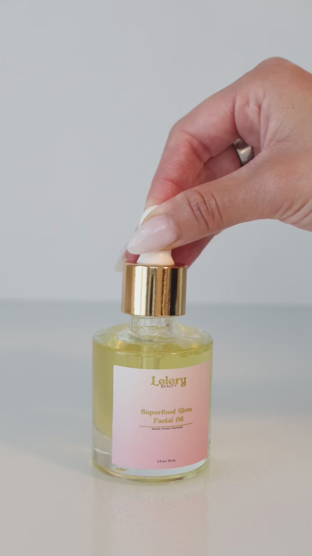 Lelery Beauty Superfood Facial Oil held in hand for scale and use.